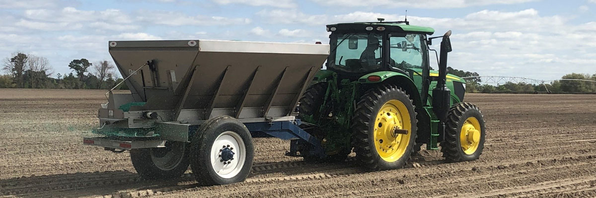 spreading fertilizer on crops